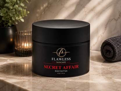 This is a man’s scented body butter with musk, amber, citrus, and woody notes. A black cosmetic jar labeled 'Flawless Skincare Secret Affair Body Butter' sits on a marble countertop with a candle, plant, and rolled towel in the background.